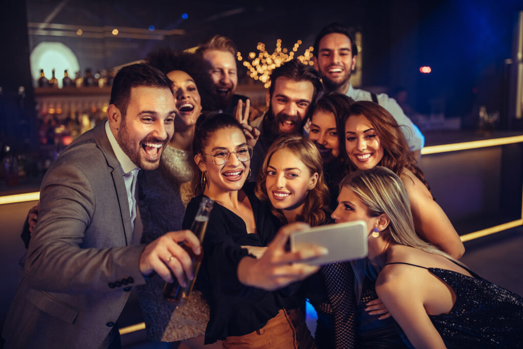 A Group Of Cheerful Friends Taking A Selfie At An Event.