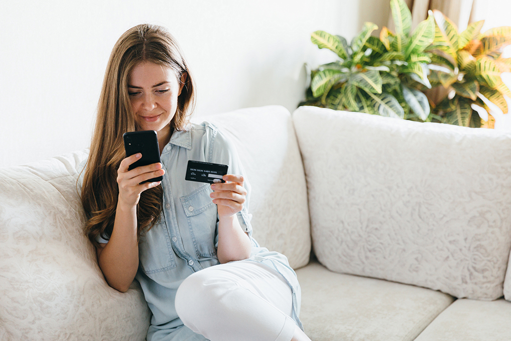How to Sell Tickets for Live Music Events with WooCommerce 3 woman using credit card and smartphone at home 2026 03 17 14 39 34 utc